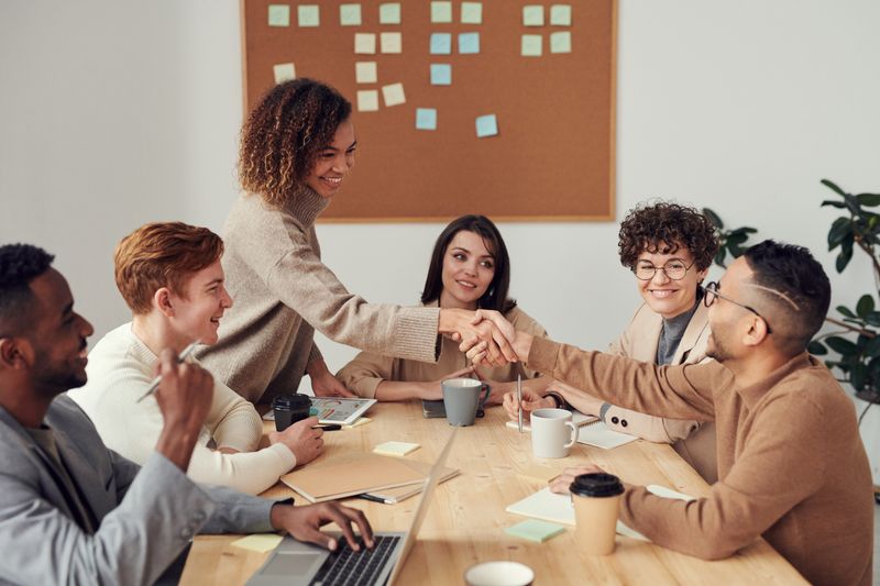 Team members having a constructive feedback conversation in a modern office