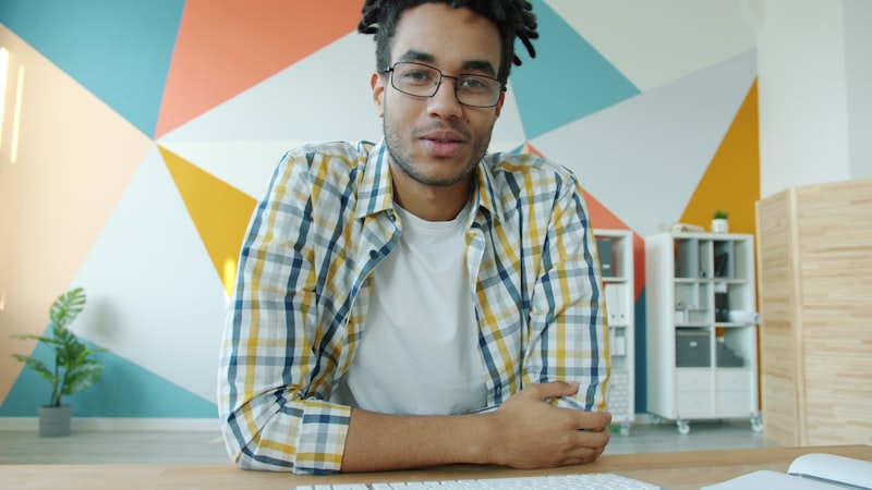 Remote worker on a video conference call from a colourful home office